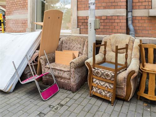 Discarded old furniture piled on a sidewalk