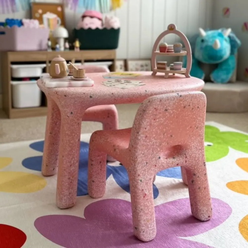 Pink speckled plastic kids table and chairs with toy tea set