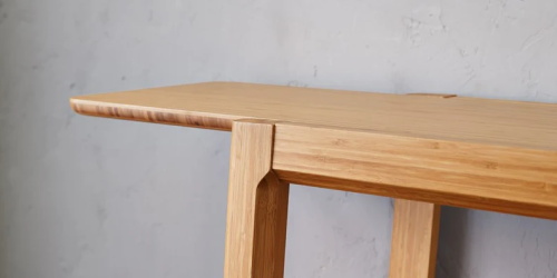 Light woodenbamboo table with modern joinery detail